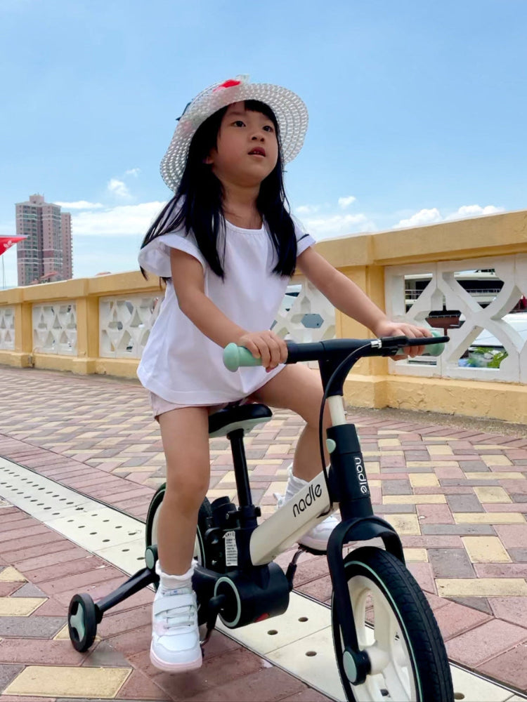 BrightKey Futurist homepage photo with a confident kid looking up in the blue sky on a bike.