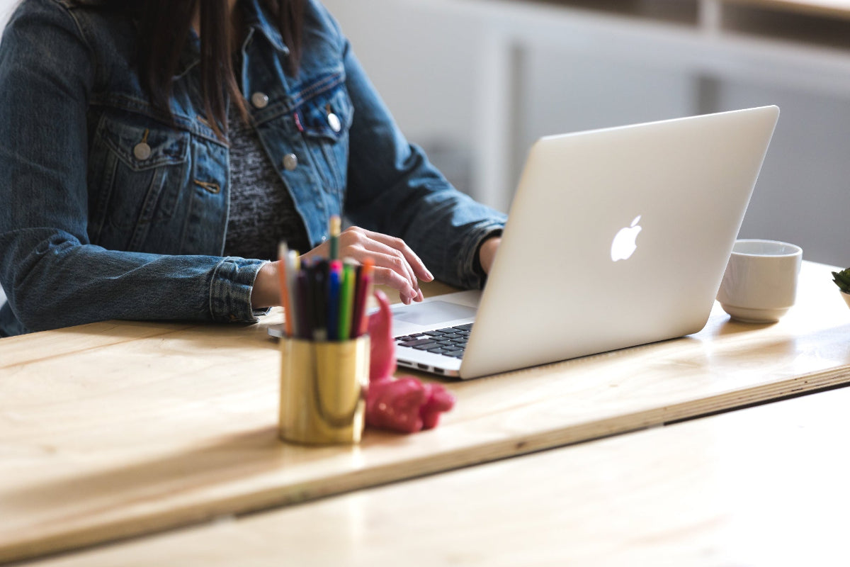 An image banner showing a lady in front of a MacBook